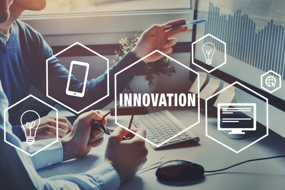 Hands at a computer with the word "Innovation"