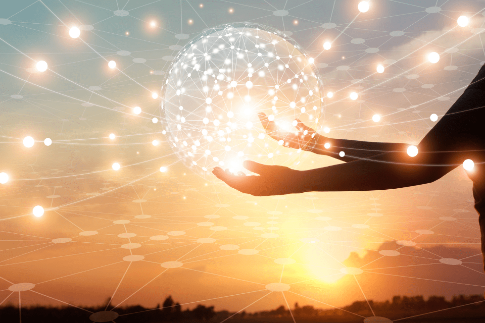 Hands hold up a ball of light