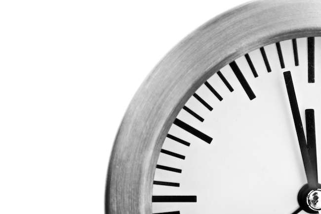 two minutes before noon on clock