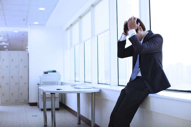 man holding his head in his hands