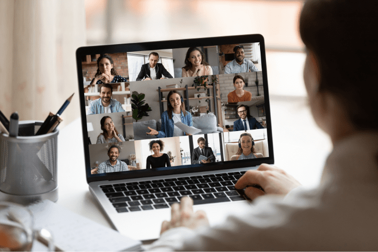 A worker attends a Zoom meeting on their laptop