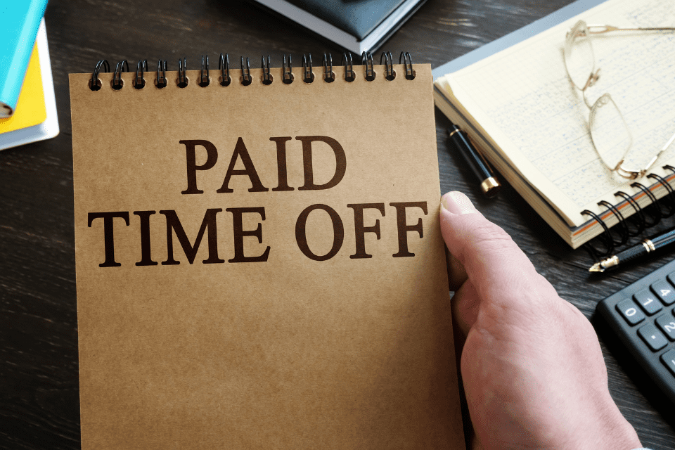 A notebook cover that says "Paid Time Off" on the front