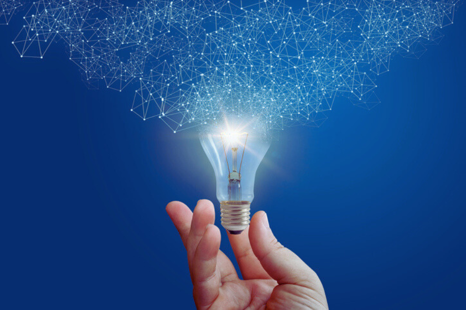 Hand holds light bulb
