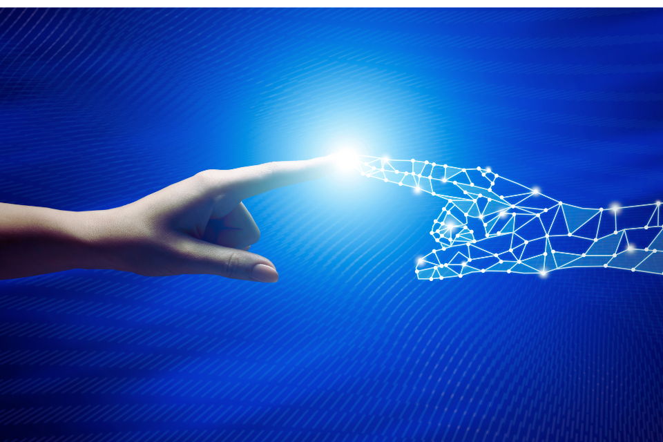 Human hand extends toward AI robot hand