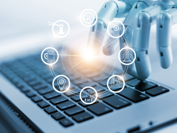 A robot hand on a laptop keyboard