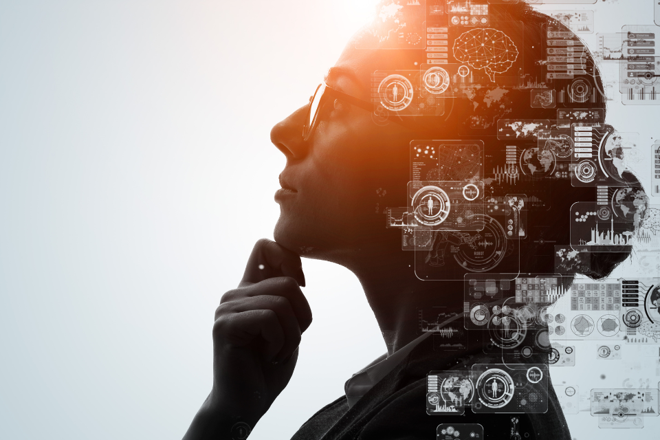 Profile of a woman's head with technology sybols superimposed on top